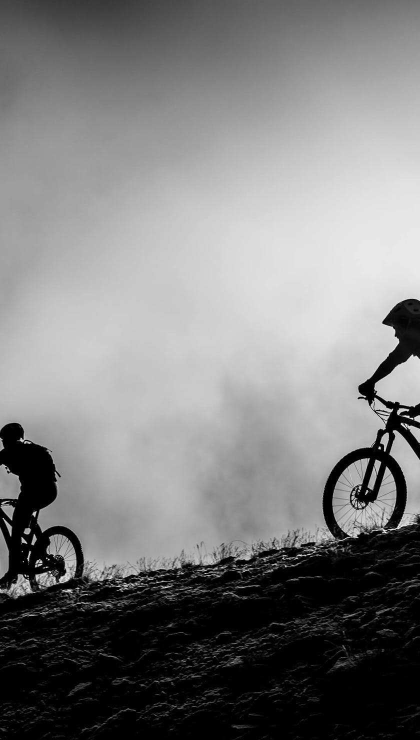 Two riders backlit by the sun