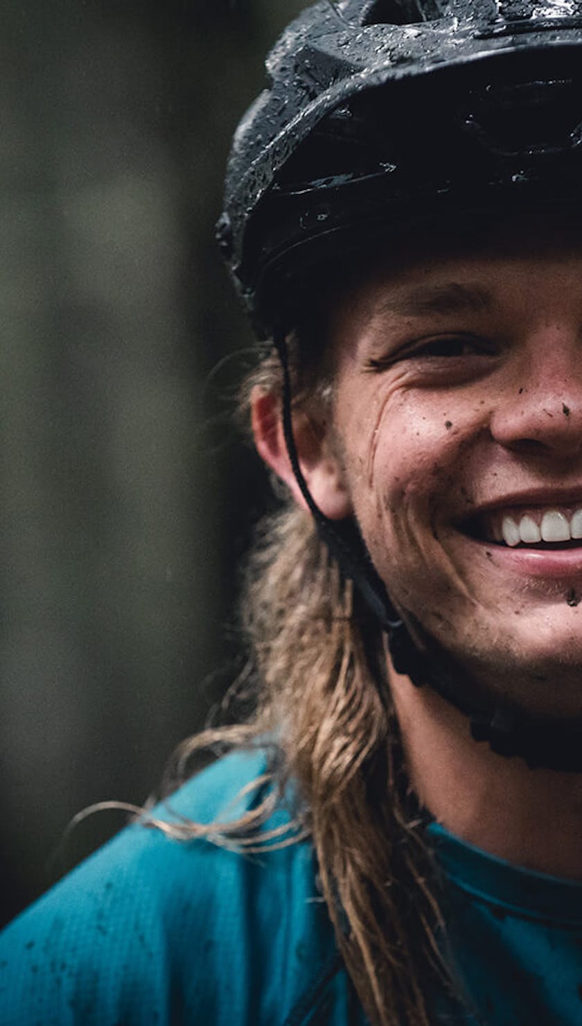 Cody Kelley smiles with mud on his face