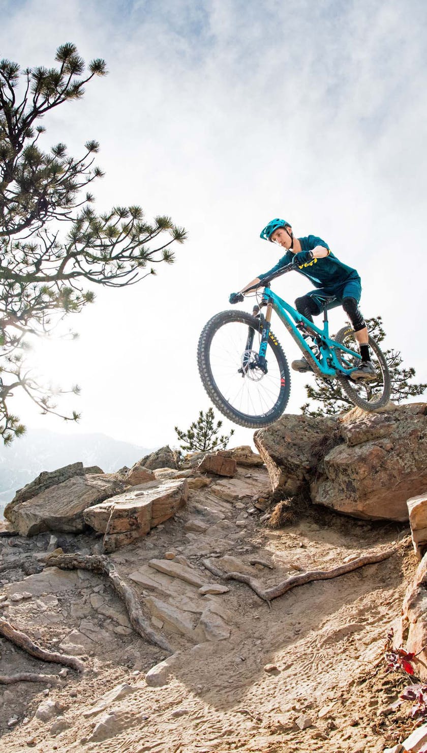 Josh jumping over rocks and roots