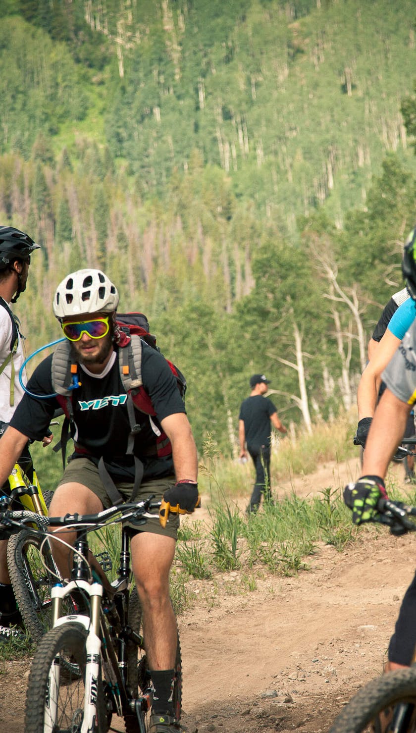 Riders hoping on their bikes at the shuttle drop off