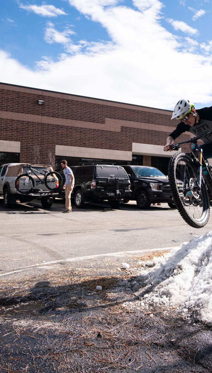 Danny Bilot jumping a snow pile in the parking lot
