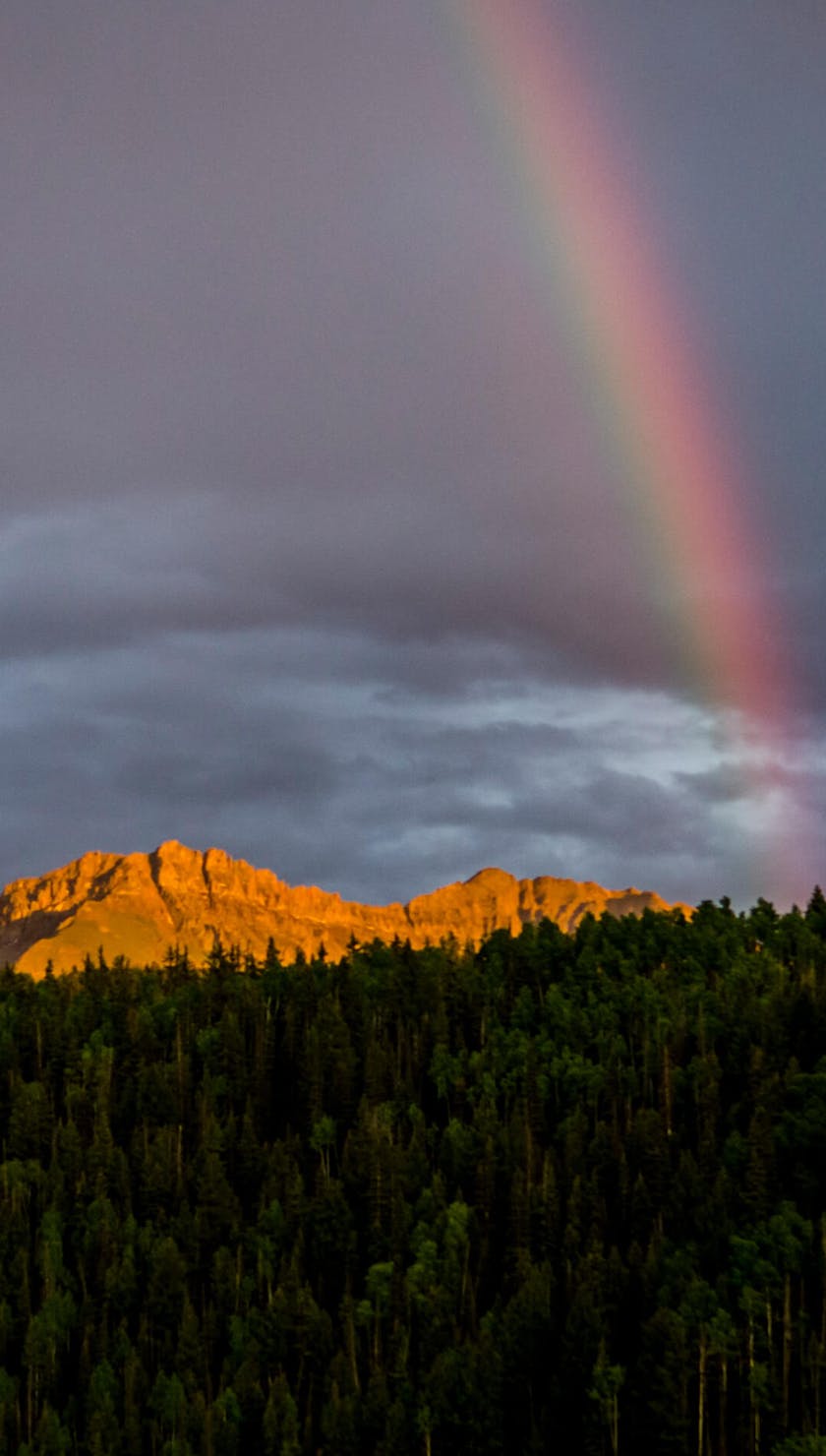 Rainbow over a sun lit ridge