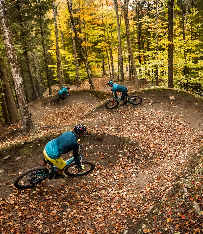 Nate Hills, Adam Morse, and Brooks Curran ride Yeti SB5's down winding single track